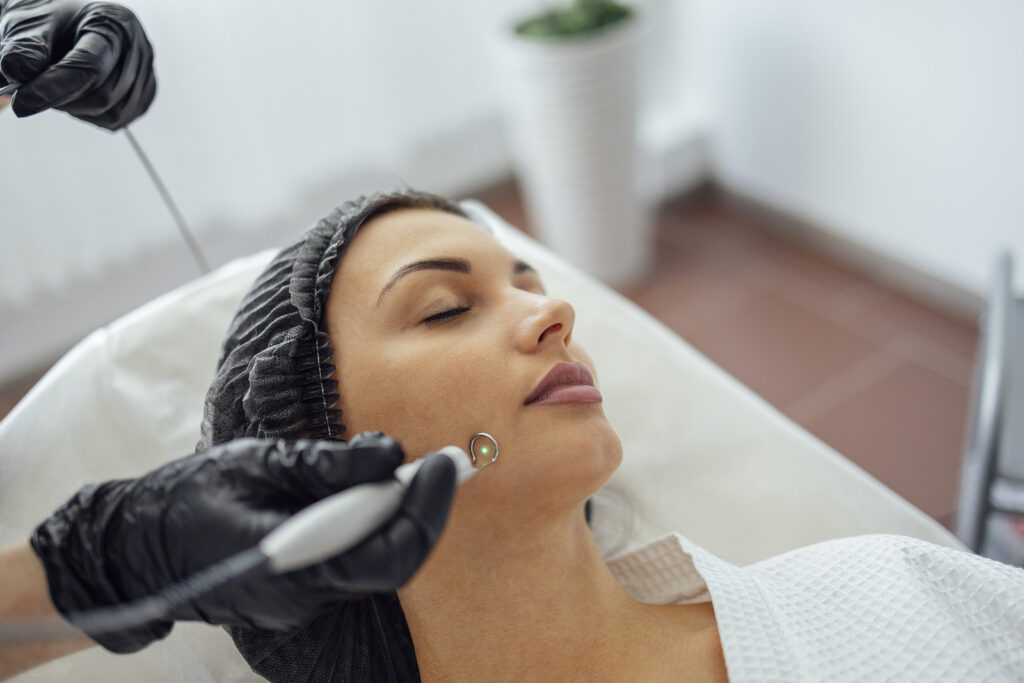 Beautiful Caucasian Young Woman Is Doing A Mole Removal Procedur