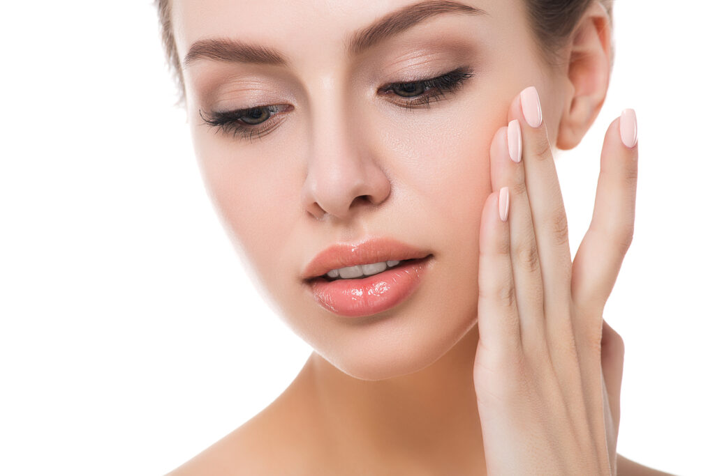 laser treatment essex - woman touching her face